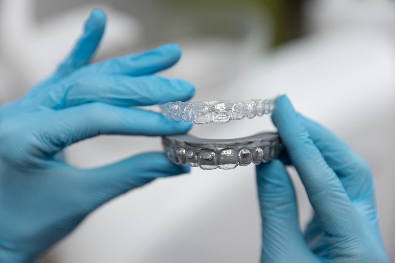 Image of a person holding an aligner